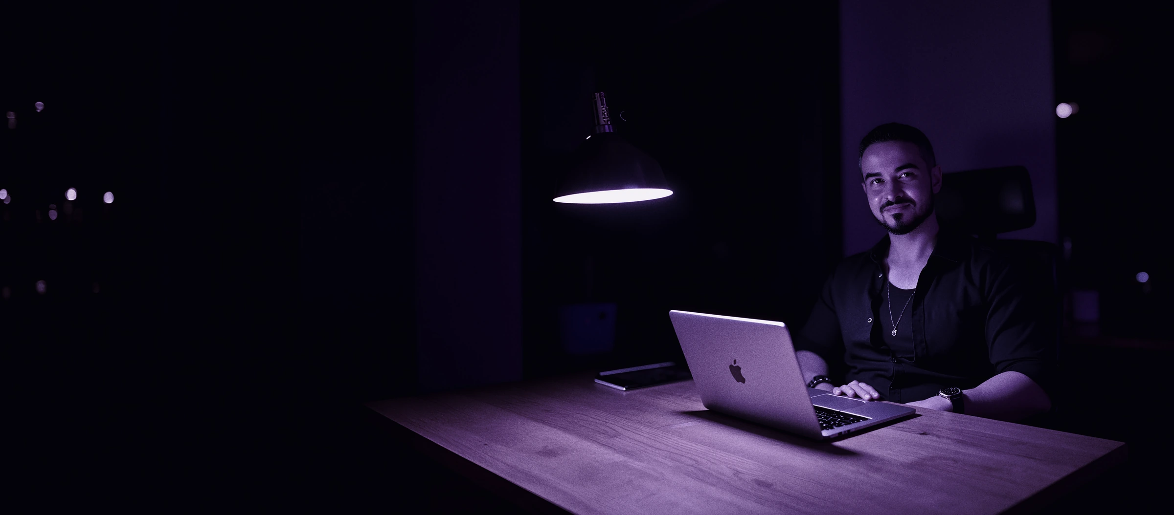 Leandro Pereira at his desk in an office at night